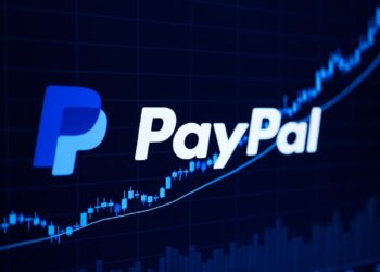 Pantalla digital con logo de PayPal y gráfico financiero ascendente de fondo.