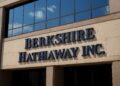Fachada moderna de las oficinas de Berkshire Hathaway con logo en alto relieve y vidrio reflectante.