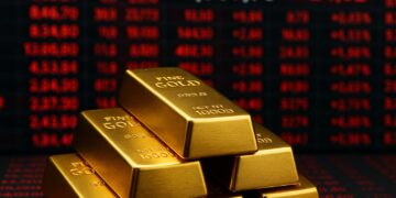 Lingotes de oro apilados frente a pantallas rojas de mercado con precios en aumento.