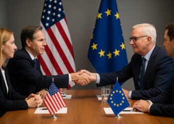 Representantes de Estados Unidos y Europa se dan la mano en una mesa de negociación con banderas oficiales