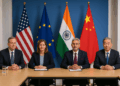 Delegados diplomáticos sentados en Bruselas con banderas de EE. UU., la Unión Europea, India y China al fondo