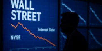 Silueta de Jerome Powell frente a pantallas de Wall Street con gráficos de tasas en descenso