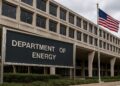 Fachada del Departamento de Energía en Washington con letrero visible y bandera estadounidense ondeando