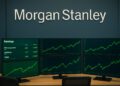 Fotografía editorial de la sala de trading de Morgan Stanley con pantallas mostrando resultados corporativos en verde y logo visible en pared