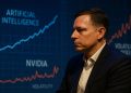 Peter Thiel observa datos de IA y volatilidad de Nvidia proyectados en una pantalla