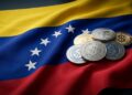 Monedas stablecoins USDT y USDC sobre bandera de Venezuela, refugio ante inestabilidad.