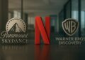 Logos de Paramount Skydance, Netflix y WBD en oficina financiera, tensión.