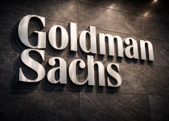 Logo físico de Goldman Sachs integrado en un muro institucional sólido.