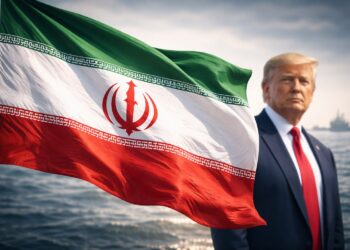 Bandera de Irán en primer plano con Trump desenfocado detrás.