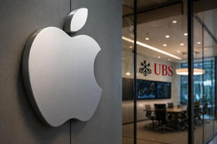 Logo de Apple en primer plano con oficina de UBS al fondo.