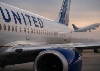 Avión de United en primer plano y otro despegando difuso.