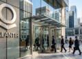 Fotografía de la entrada principal de la sede de Palantir, con su logo de acero cepillado y un ambiente empresarial.