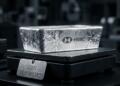 Un lingote de plata HSBC sobre una báscula negra con una etiqueta: 'XAG SOBREVALORADO'.
