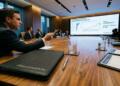 Ejecutivo de JPMorgan gesticula ante una pantalla con análisis de Broadcom (AVGO)
