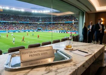 Letrero de suite de Flutter en una barra de mármol, con vista de un partido de fútbol.