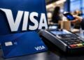 Logotipo de Visa junto a una tarjeta bancaria y un terminal de pago.